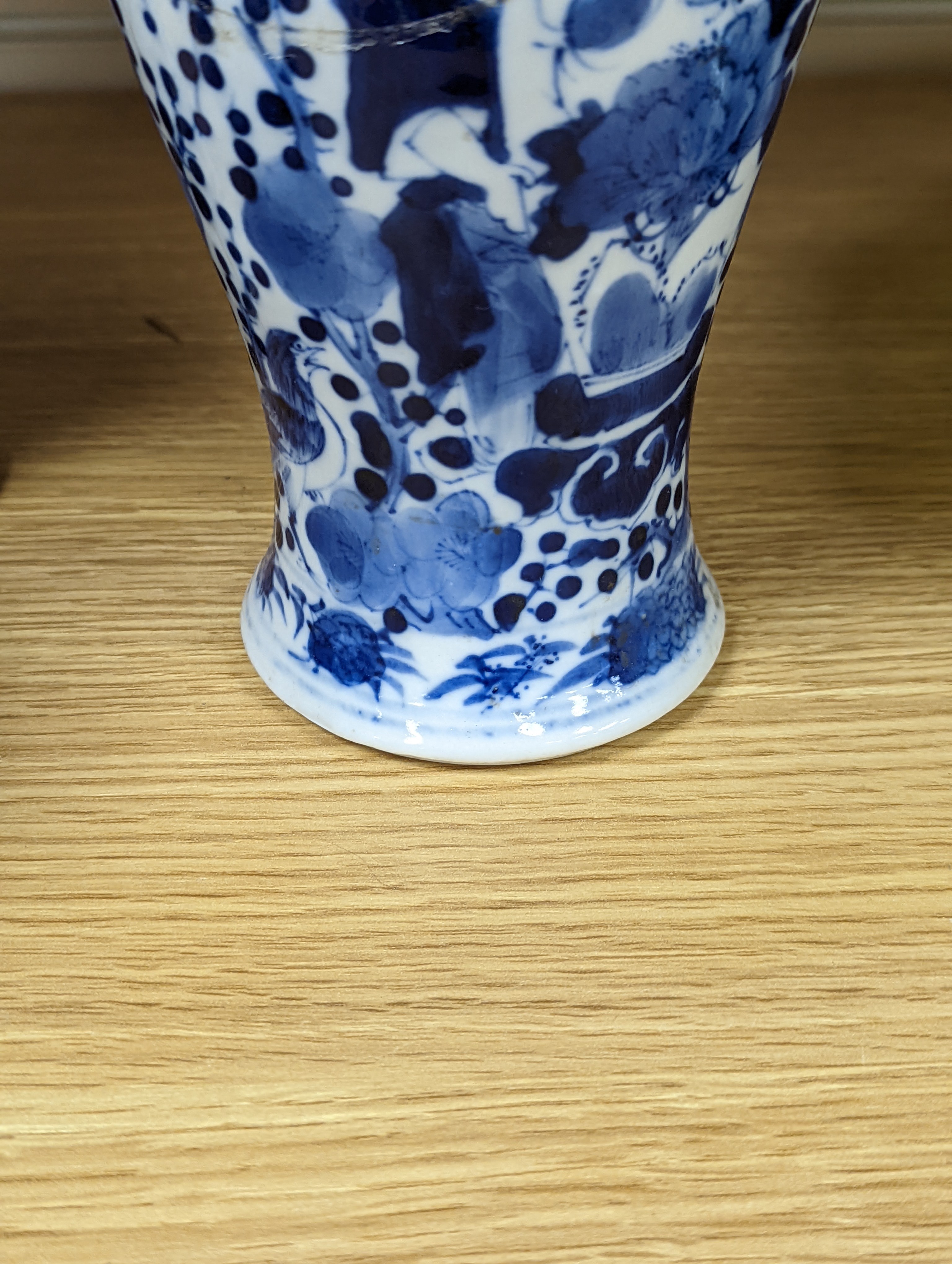 A pair of 19th century Chinese blue and white vases, a prunus vase and cover and a similar jar (4), pair of vases 24 cms high.